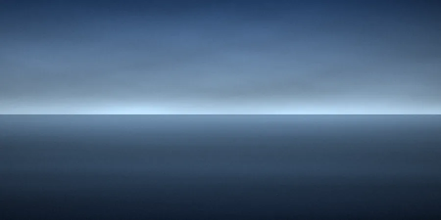 Deep blue sky over still water